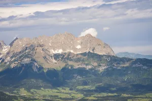 Cloudy Mountain Scenery Stampe: Massive mountain range under dramatic cloud formations and dense forest