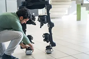 Exoskeleton Technology Stampe: Mechanical exoskeleton engineer checking robot before delivery to customer