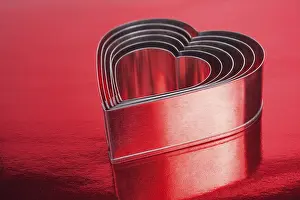 Red Background Stampe: Some of the metal hearts shaped over red background