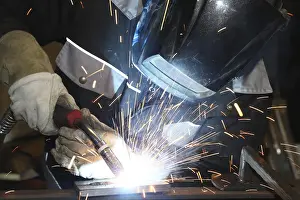 Industrial Equipment Stampe: Metalworker during welding work in his workshop