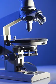 Laboratory Equipment Stampe: Microscope on the table in laboratory with blue light
