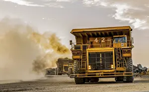 Construction Site Equipment Stampe: Mining dump trucks transporting Platinum ore for processing