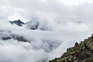 Austria Mountain Peaks Stampe: Mountain peak rises from clouds