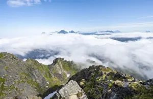 Cloudy Sky Over Mountains Stampe: Mountain peaks above the clouds