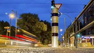 Road Safety In Europe Stampe: Moving trams at an intersection with a speed camera column
