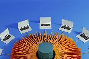 Artificial Intelligence Technology Stampe: Multiple laptops surround a central data hub