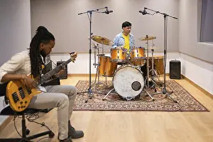 Musician Collaboration Stampe: Two musicians collaborating in a modern recording studio