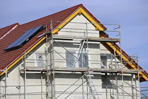 Single Family Home Construction Stampe: New building with completed basic rendering of the exterior facade New building with completed basic rendering of