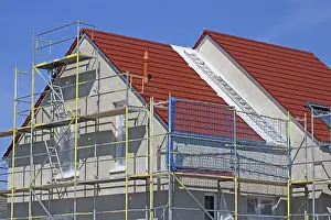 Construction Site Image Stampe: New building with completed basic rendering of the exterior facade New building with completed basic rendering of