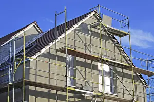 House Building Process Stampe: New building with completed basic rendering of the exterior facade New building with completed basic rendering of