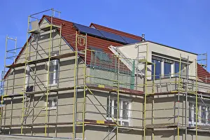 Residential Building Shell Construction Stampe: New building with completed basic rendering of the exterior facade New building with completed basic rendering of