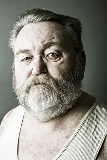Caucasian Man Photo Stampe: Obese senior with a full beard and in his undershirt