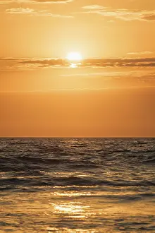 Red Sunset Background Stampe: Ocean waves on sunset with setting sun background
