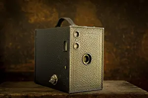Old Camera Stampe: Old camera on brown background