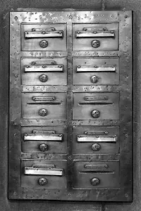 Deserted Post Office Stampe: An old mailbox mounted on a wall
