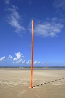 Juist Island Beach Stampe: Orange-red marker posts on the beach