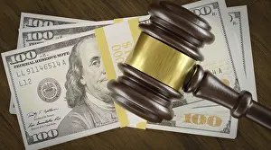 High Angle Shot Stampe: Overhead of gavel resting on a table and stack of thousands of dollars