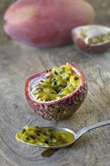 Tropical Fruit Stampe: A passion fruit, opened with pulp on a spoon