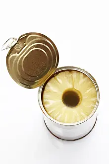 Studio Shot Of Pineapple Stampe: Pineapple slices in an opened tin
