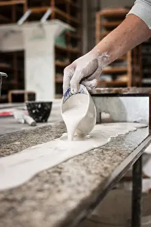 Handicraft Skills Stampe: A plasterer pours plaster onto a workbench