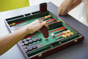 Classic Board Games Stampe: A player makes a move in a backgammon game