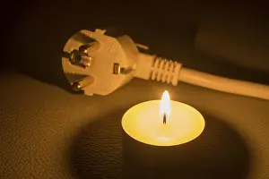 Electricity Supply Infrastructure Stampe: A plug is next to a burning candle