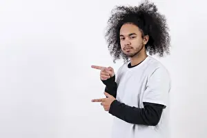 Hispanic Ethnicity Male Model Stampe: Pointing to the left at a copy paste space
