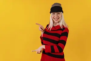 Yellow Background Cutout Stampe: Pointing to the left in a wool cap