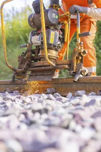 Railway Tracks Stampe: Worker using machine for track work