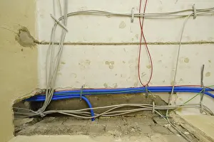 Construction Site Germany Stampe: Power cables, empty conduits and network cables under the ceiling