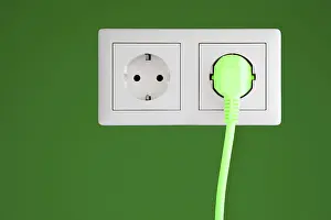 Renewable Energy Symbol Stampe: Power socket with a green plug