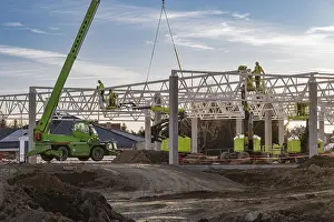 Industrial Construction Project Stampe: Professional construction crew using a telescopic handler