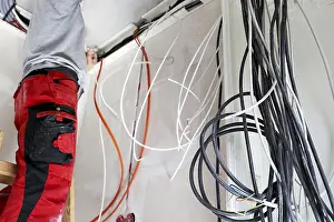 Construction Site Labourer Stampe: Professional electrical installation on a building shell