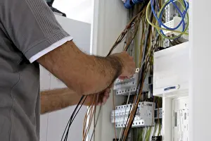 Professional Electrical Installation Stampe: Professional electrical installation on a building shell