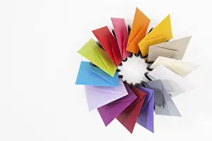 White Table Studio Shot Stampe: Propeller of colored envelopes on the white table