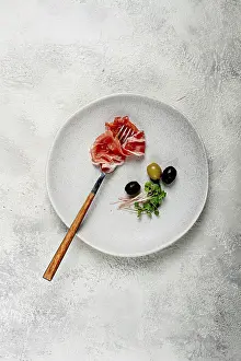 Dried Meat Products Stampe: Prosciutto on a fork, top view