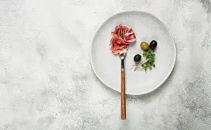 Gourmet Snack Meal Stampe: Prosciutto on a fork, top view