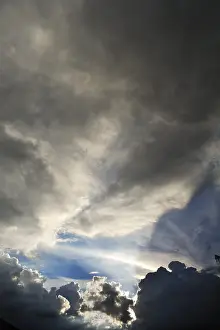 Gloomy Cloudy Atmosphere Stampe: Rain clouds with sun breaking through
