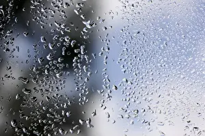 Cloudy Sky With Raindrops Stampe: Rain drops on window as the clouds clear behind