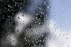 Cloudy Sky With Raindrops Stampe: Rain drops on window as the clouds clear behind