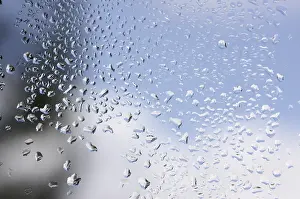 Raindrops On Window Stampe: Rain drops on window as the clouds clear behind