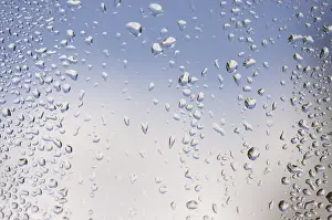 Cloudy Sky With Raindrops Stampe: Rain drops on window as the clouds clear behind