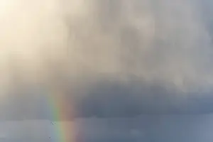 Cloudy Sky With Rainbow Stampe: Rainbow appears in rain clouds in spring