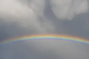 Cloudy Sky With Rainbow Stampe: Rainbow appears in rain clouds in spring