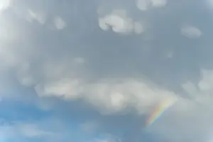 Cloudy Sky With Rainbow Stampe: Rainbow appears in rain clouds in spring