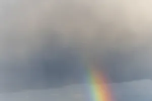 Cloudy Sky With Rainbow Stampe: Rainbow appears in rain clouds in spring