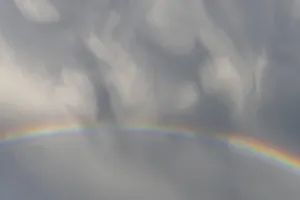 Cloudy Sky With Rainbow Stampe: Rainbow appears in rain clouds in spring