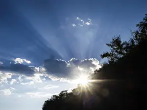 Empty Austrian Landscapes Stampe: Rays of sunshine breaking through clouds