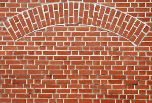 Deserted Building Architecture Stampe: Red brick wall with an arch