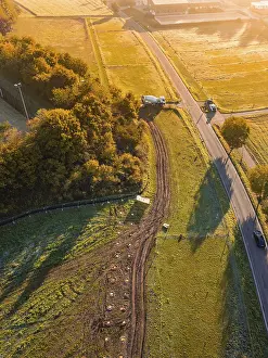Atmospheric Autumn Mood Photo Stampe: Road through fields with construction